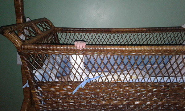 Photo: Hand on crib rail
