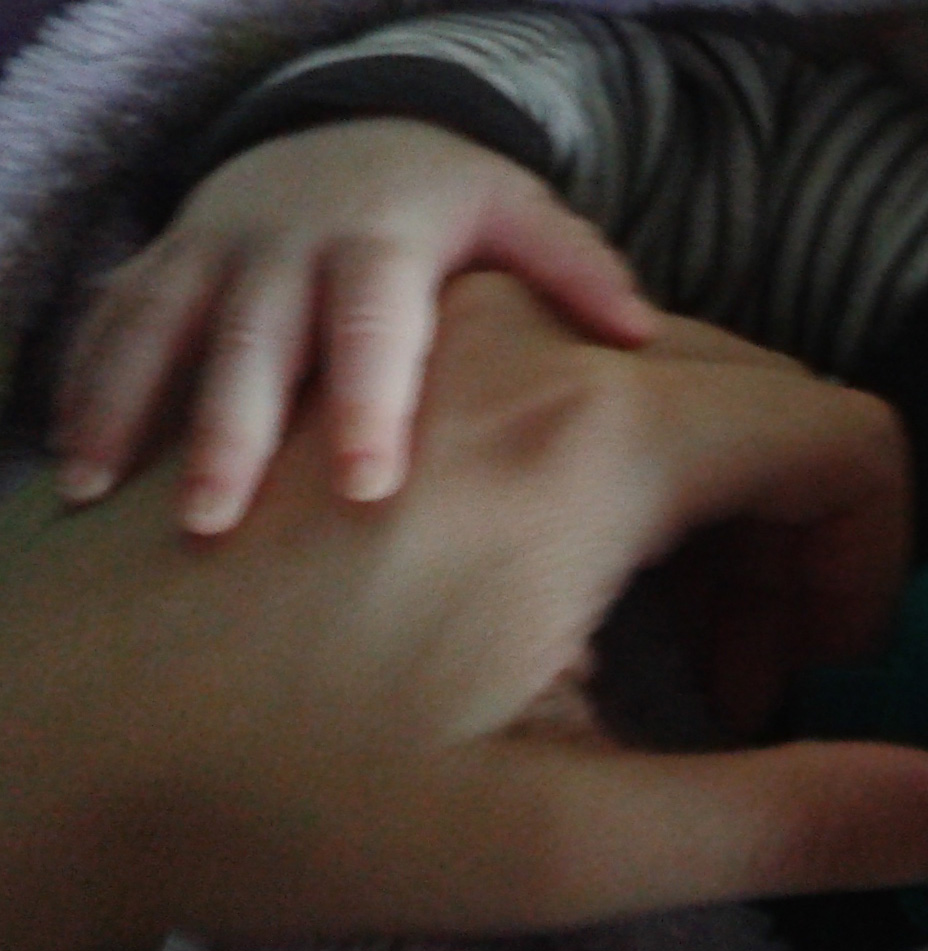 Picture of small hand resting on bigger hand