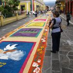 Lucia and Victor looking a sawdust carpet