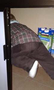 Victor exploring a cupboard