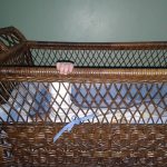 Photo of baby's hand on crib rail