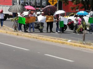 Photo of demonstrators holding up signs
